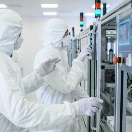 Team of Scientists in Sterile Protective Clothing Work on a Modern Industrial 3D Printing Machinery. Pharmaceutical, Biotechnological and Semiconductor Creating / Manufacturing Process.
